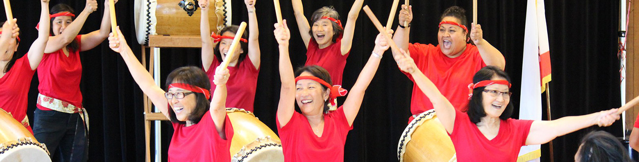 Staff members taiko drumming 