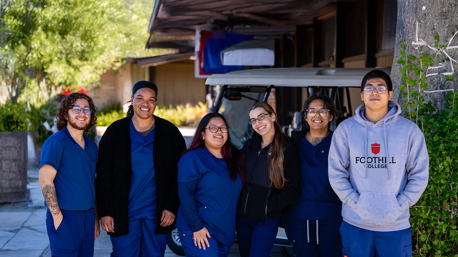 Group of six dental hygienist students smiling.