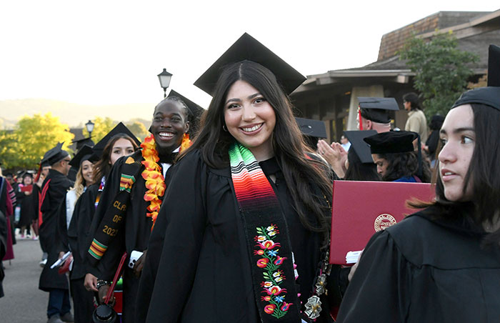 group of student graduates holding degree covers