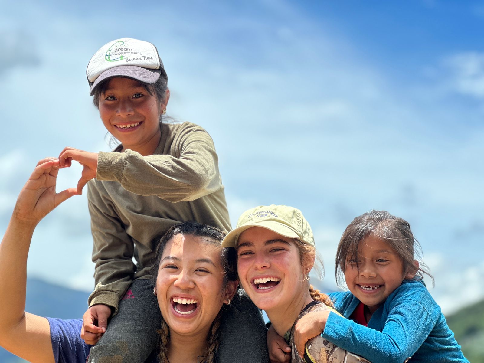 two young adult girls with two children