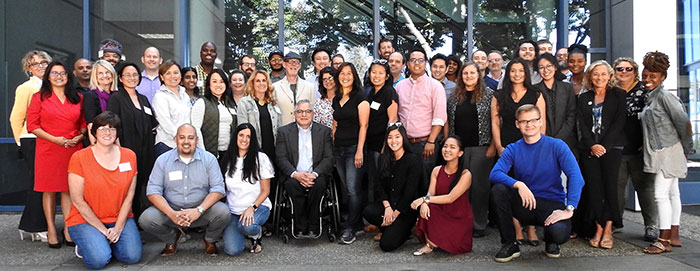 Large group of faculty, staff and managers smiling