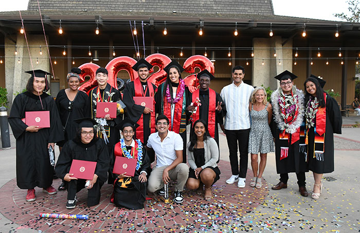 Large group of graduates with faculty 